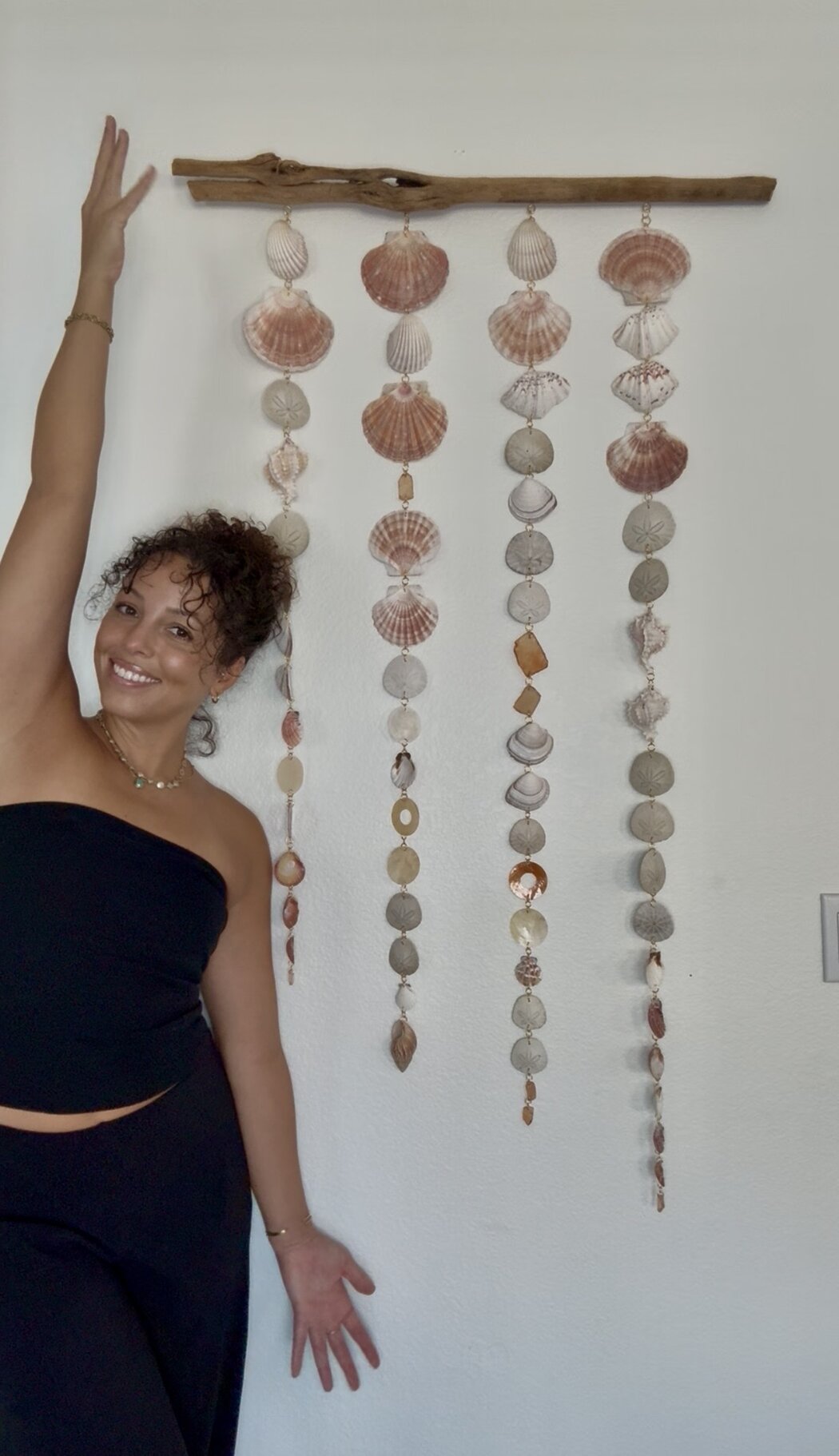 The Desert Mermaid Art maker with a set of handcrafted shell wall hangings